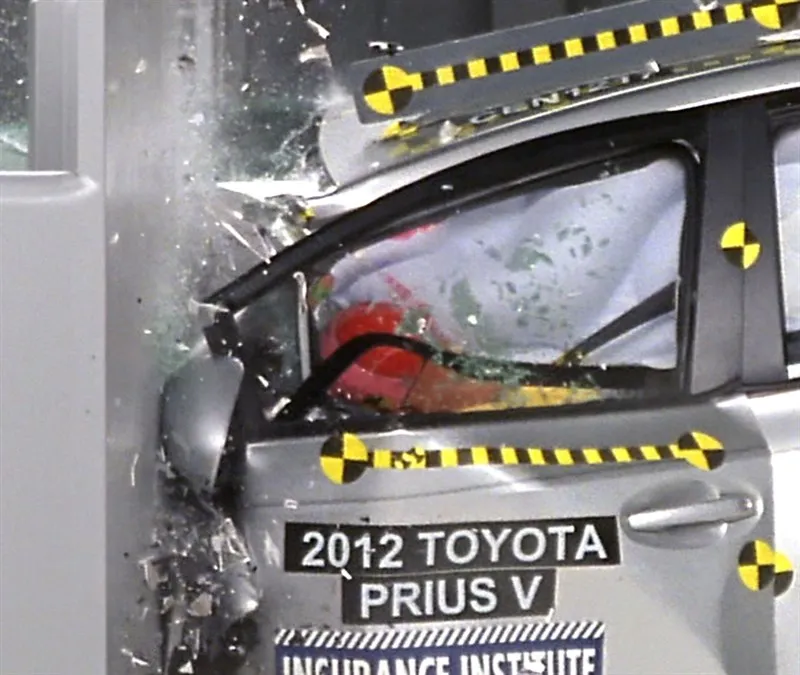 Close-up of the 2012 Toyota Prius v's driver window during the impact, as glass breaks and the side curtain airbag deploys.